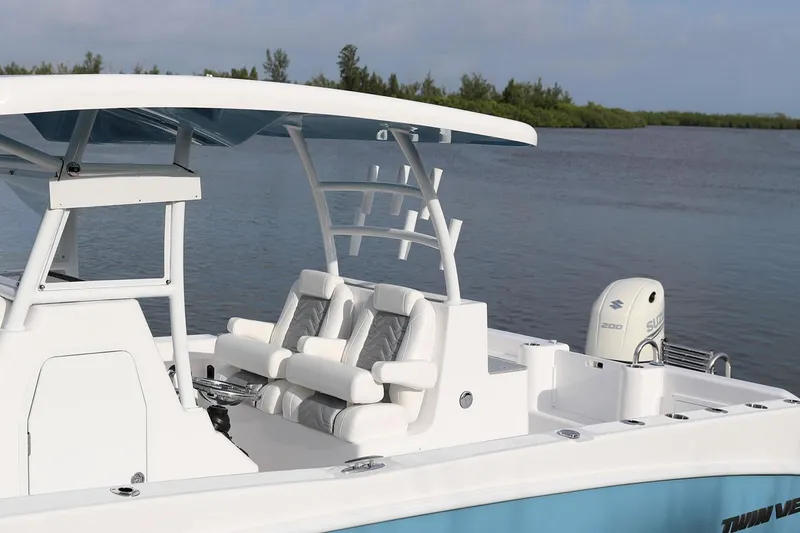 Slide: The Image of Manufacturer Provided Image: 2021 Twin Vee 280 CC GF boat on calm water with lush green background. - 6