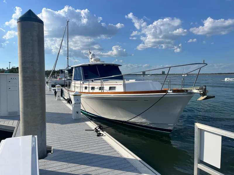 Slide: The Image of 2002 Grand Banks 43 Eastbay HX yacht docked at marina under blue sky. - 11