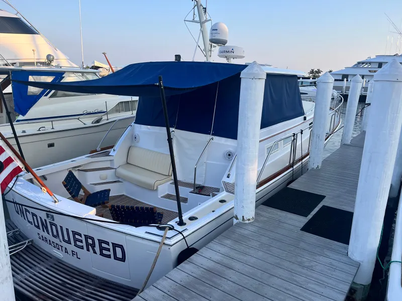 Slide: The Image of 2002 Grand Banks 43 Eastbay HX yacht docked with blue canopy and seating area. - 14