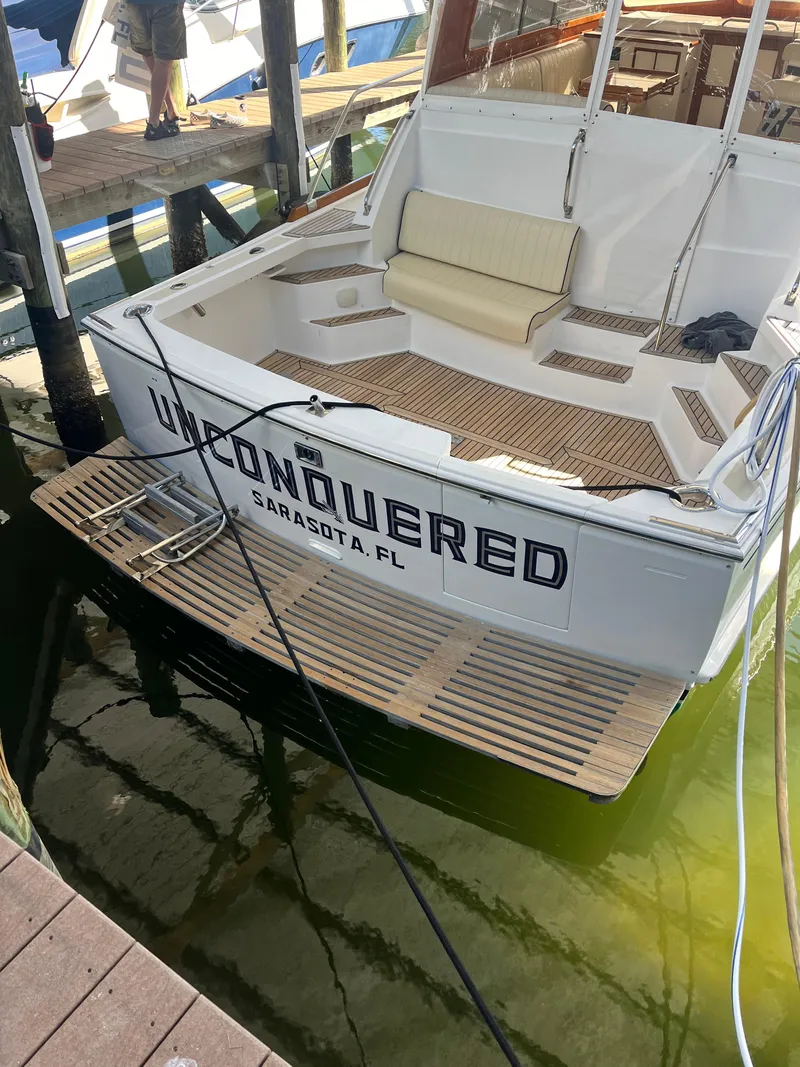 Slide: The Image of Grand Banks 43 Eastbay HX 2002 yacht docked, named "Unconquered," in Sarasota, Florida. - 15