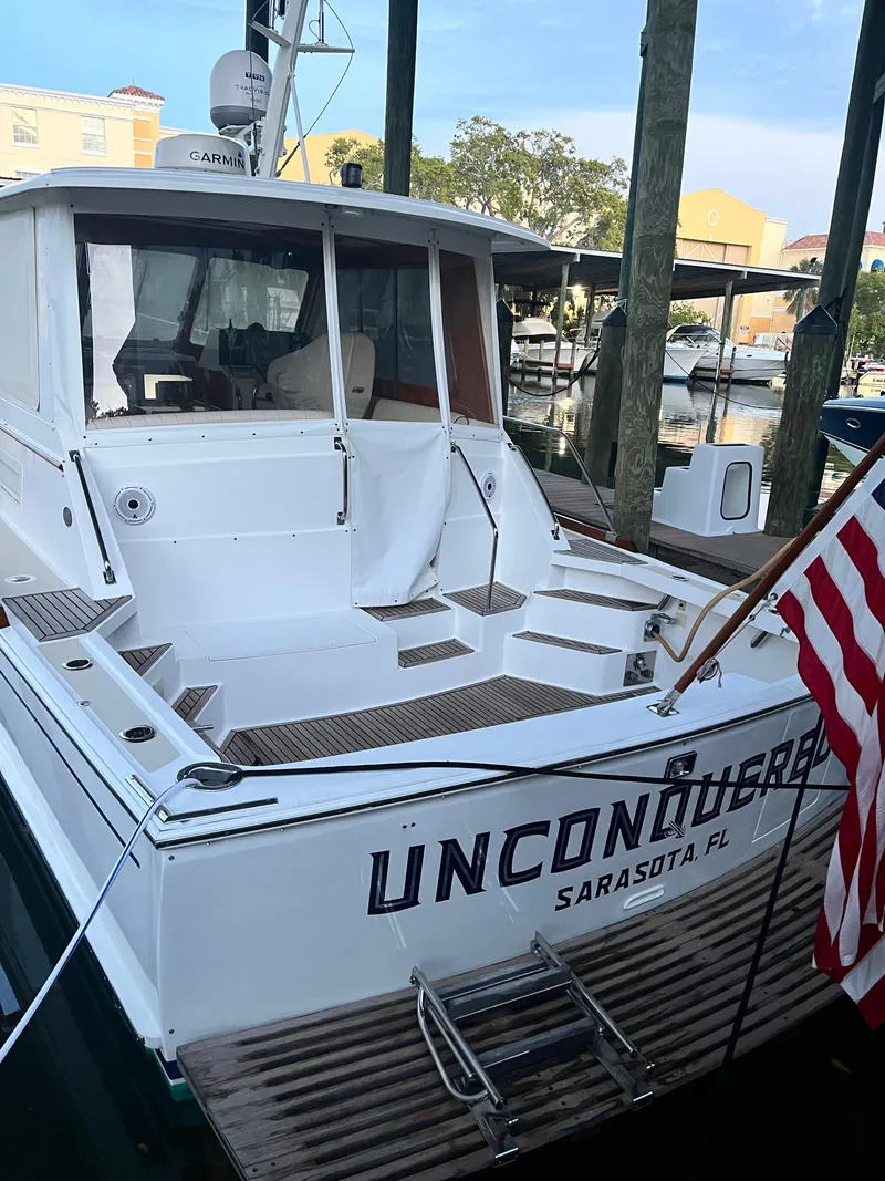 Slide: The Image of 2002 Grand Banks 43 Eastbay HX yacht docked in Sarasota, Florida, with American flag. - 17