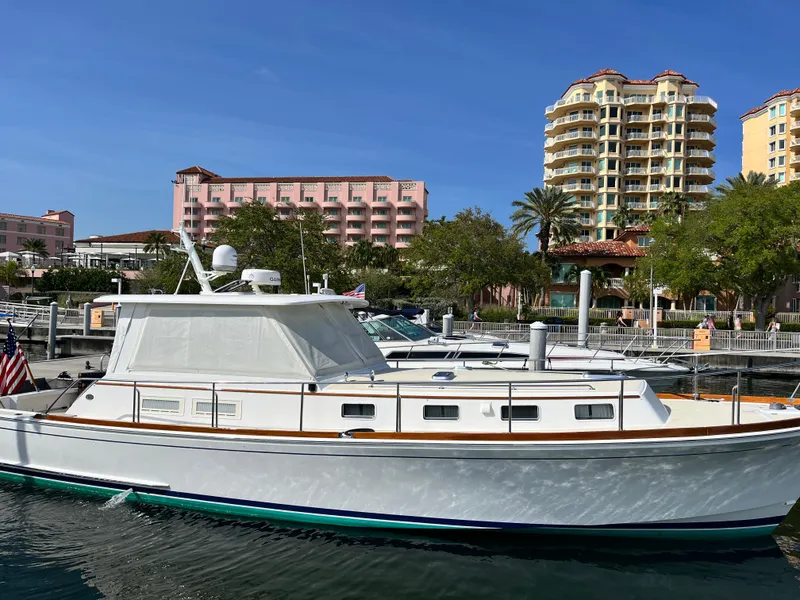 Slide: The Image of 2002 Grand Banks 43 Eastbay HX yacht docked near waterfront buildings. - 2