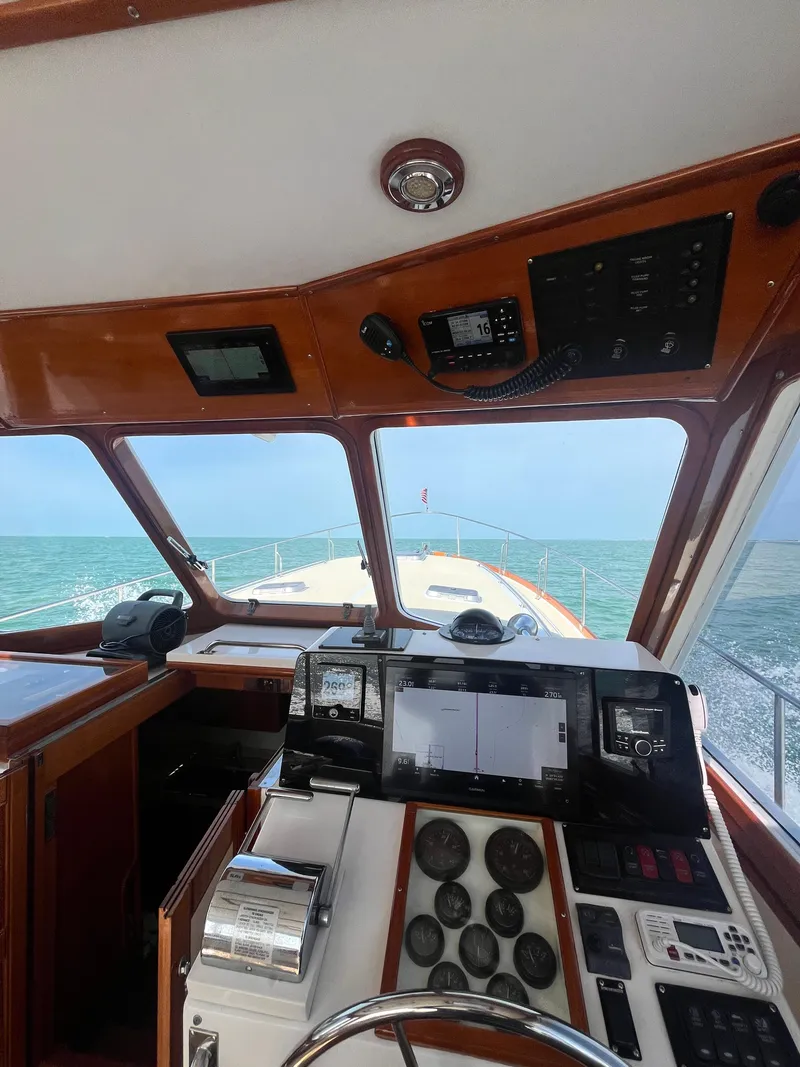 Slide: The Image of Interior view of 2002 Grand Banks 43 Eastbay HX yacht helm, overlooking the ocean. - 23