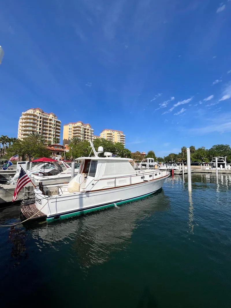 Slide: The Image of 2002 Grand Banks 43 Eastbay HX yacht docked in marina with clear blue sky. - 3