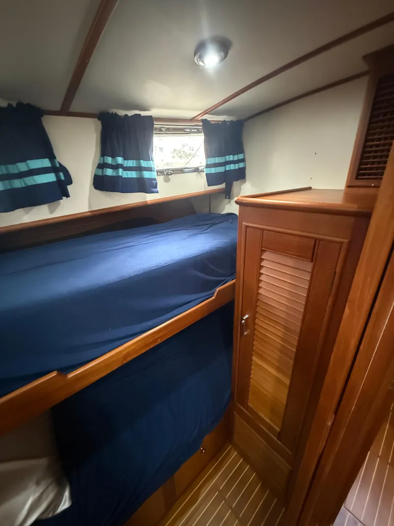 Slide: The Image of Interior cabin of 2002 Grand Banks 43 Eastbay HX with bunk beds and wooden cabinetry. - 32