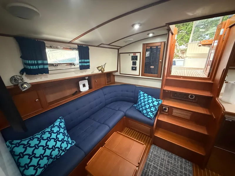 Slide: The Image of Interior of 2002 Grand Banks 43 Eastbay HX with blue seating and wooden accents. - 33