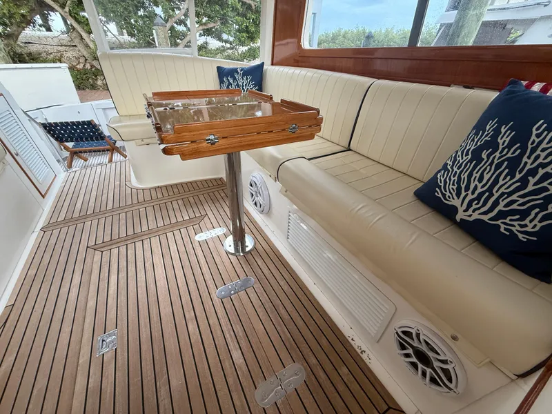 Slide: The Image of Luxurious 2002 Grand Banks 43 Eastbay HX yacht interior with teak flooring and cushioned seating. - 39