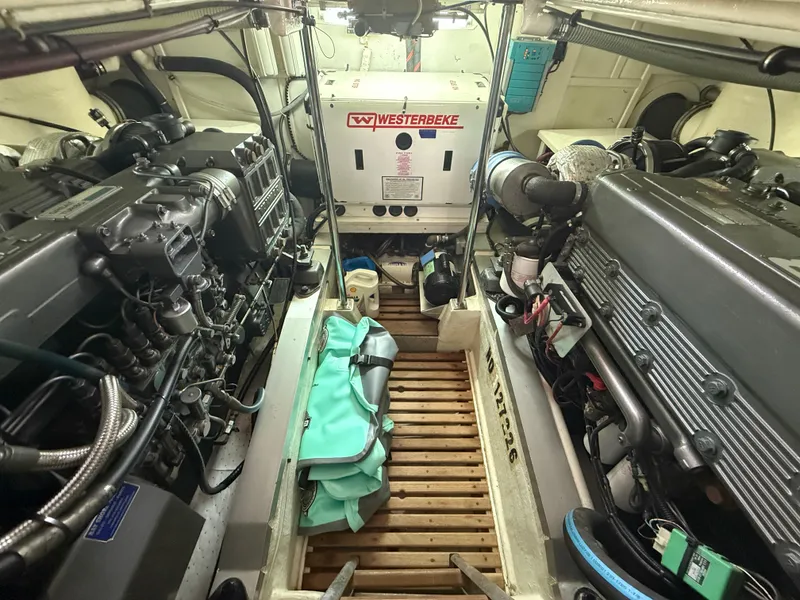 Slide: The Image of Engine room of 2002 Grand Banks 43 Eastbay HX with twin engines and Westerbeke generator. - 41