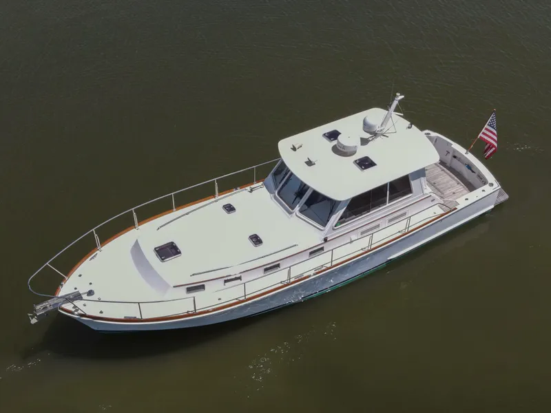 Slide: The Image of 2002 Grand Banks 43 Eastbay HX yacht on calm water, aerial view. - 5