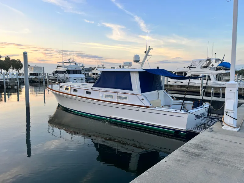 Slide: The Image of 2002 Grand Banks 43 Eastbay HX yacht docked at marina during sunset. - 7