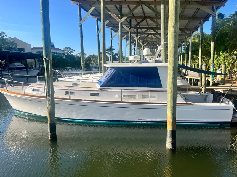 Slide: The Image of 2002 Grand Banks 43 Eastbay HX yacht docked under a covered marina. - 8