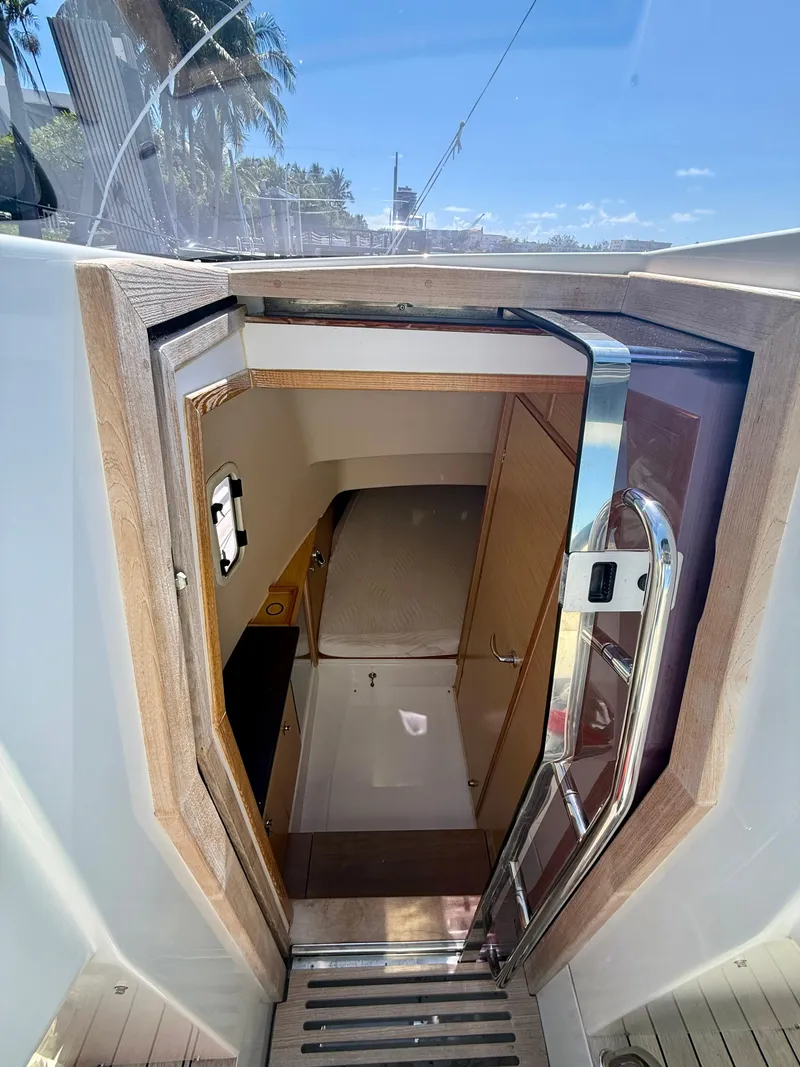 Slide: The Image of Interior view of 2019 Fjord 36' Open yacht cabin with wooden accents and compact design. - 16