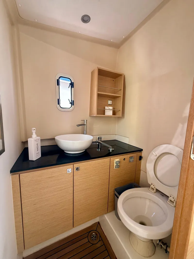 Slide: The Image of 2019 Fjord 36' Open yacht bathroom with modern sink and toilet, wooden cabinetry. - 19