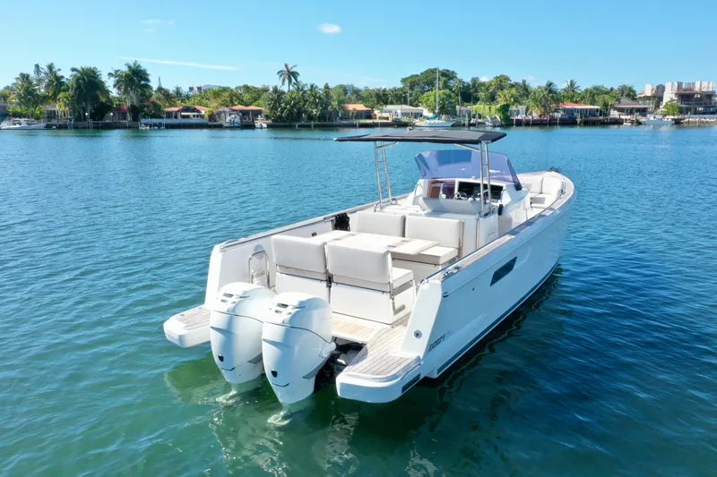 Slide: The Image of 2019 Fjord 36' Open boat on calm water, featuring dual outboard engines. - 2