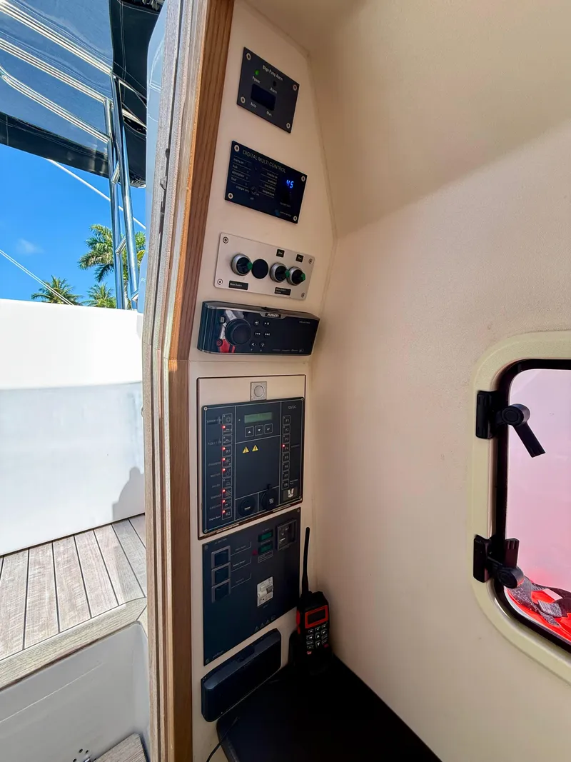 Slide: The Image of Control panel inside a 2019 Fjord 36' Open boat, featuring navigation and communication equipment. - 20