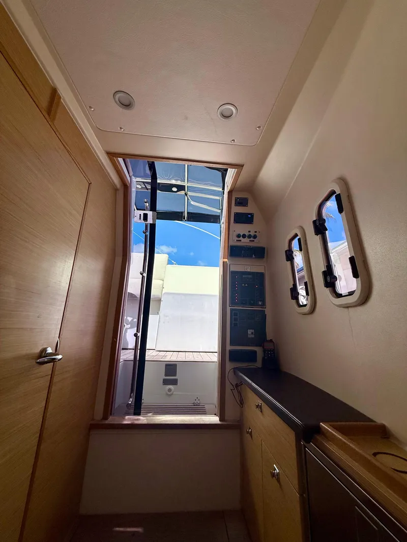 Slide: The Image of Interior view of 2019 Fjord 36' Open yacht, featuring control panels and portholes. - 21