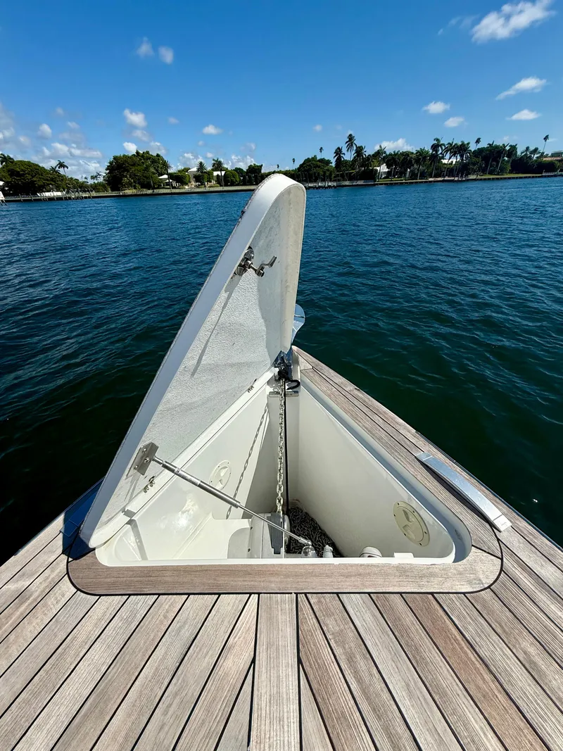 Slide: The Image of Open anchor hatch on 2019 Fjord 36' Open boat, docked on a sunny day. - 6