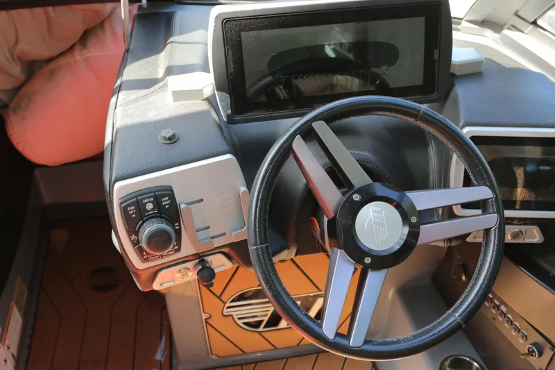Slide: The Image of 2019 Malibu Wakesetter 22 MXZ dashboard with steering wheel and control panel. - 10