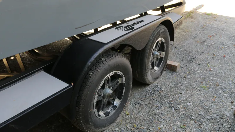 Slide: The Image of Trailer wheels of a 2019 Malibu Wakesetter 22 MXZ on gravel. - 13