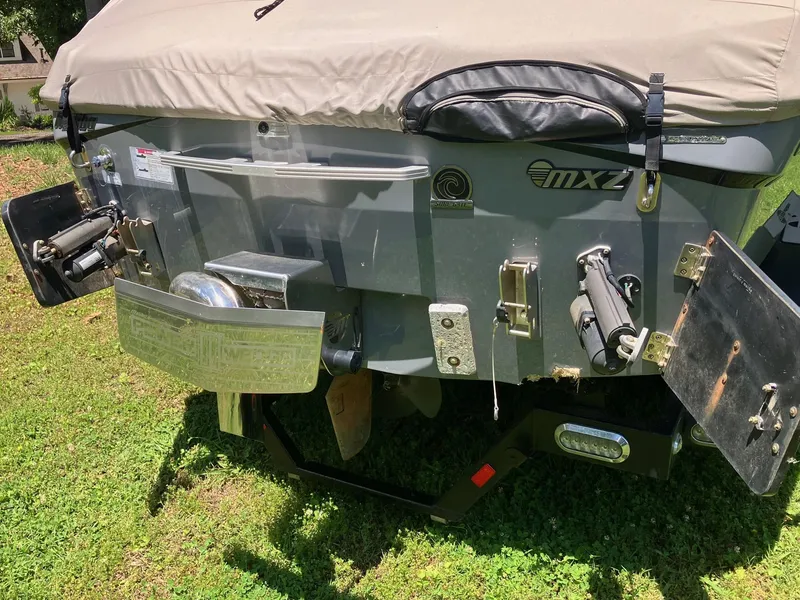 Slide: The Image of Rear view of a 2019 Malibu Wakesetter 22 MXZ boat on grass. - 15