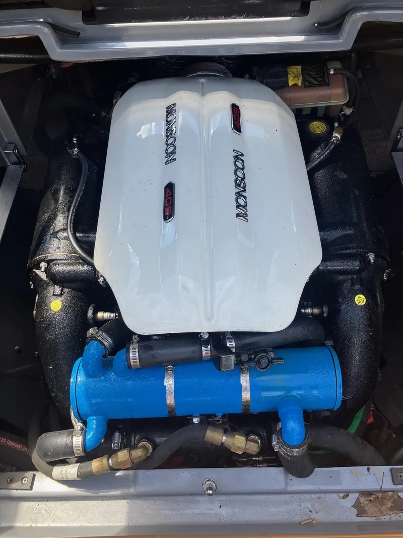 Slide: The Image of Engine of 2019 Malibu Wakesetter 22 MXZ with Monsoon cover and blue components. - 19