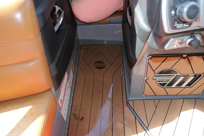 Slide: The Image of 2019 Malibu Wakesetter 22 MXZ interior with tan leather seats and sleek dashboard design. - 23