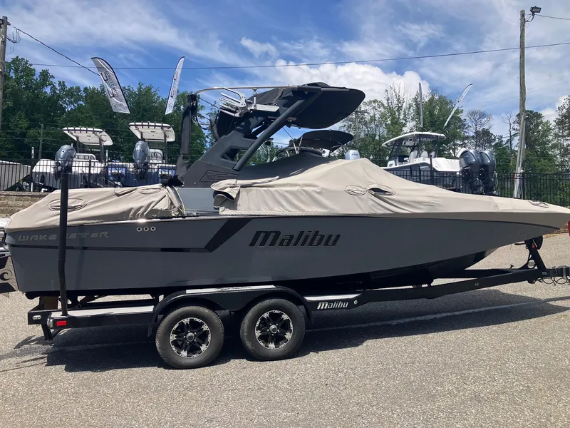 Slide: The Image of 2019 Malibu Wakesetter 22 MXZ boat on trailer, covered, with clear sky background. - 3