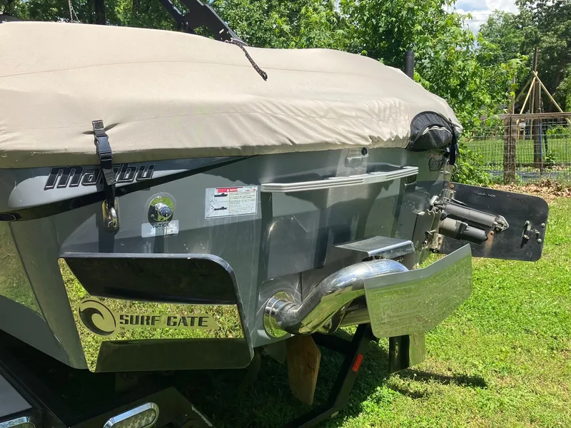 Slide: The Image of 2019 Malibu Wakesetter 22 MXZ boat with cover, featuring Surf Gate technology. - 4