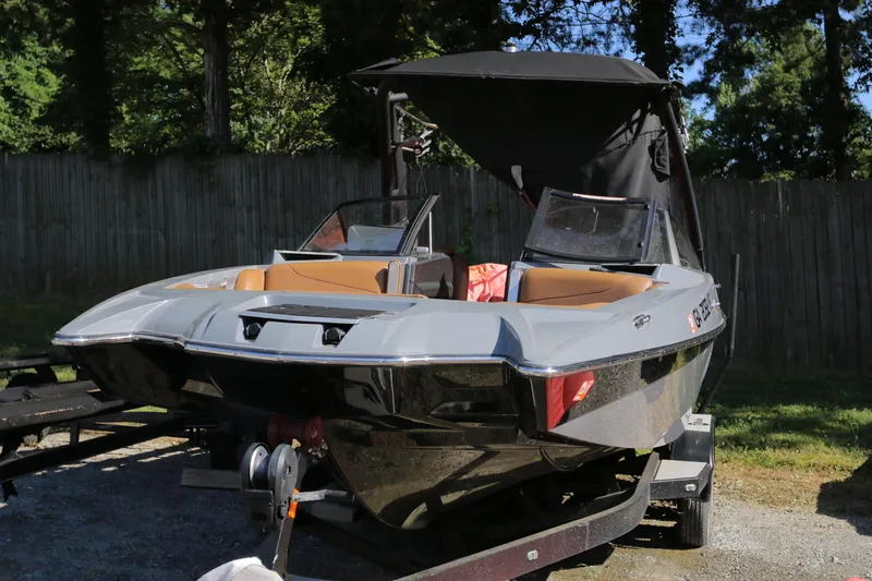Slide: The Image of 2019 Malibu Wakesetter 22 MXZ boat on trailer, parked outdoors. - 6