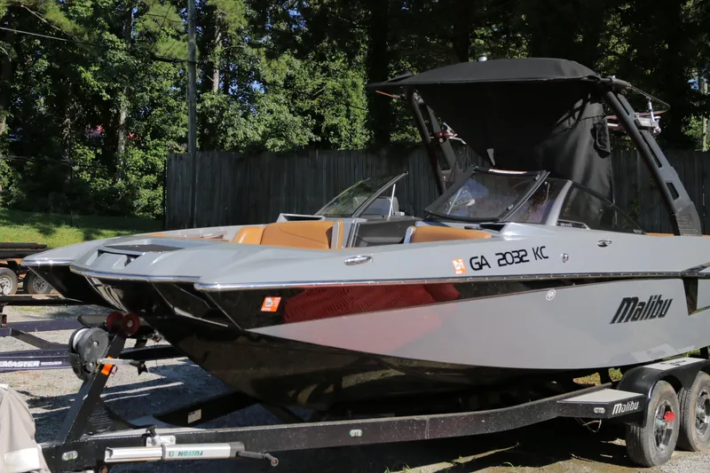 Slide: The Image of 2019 Malibu Wakesetter 22 MXZ boat on trailer, parked outdoors. - 7