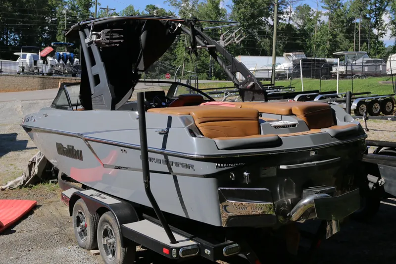 Slide: The Image of 2019 Malibu Wakesetter 22 MXZ boat on trailer, parked outdoors. - 8
