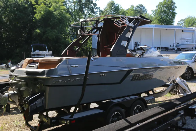 Slide: The Image of 2019 Malibu Wakesetter 22 MXZ boat on trailer, parked outdoors. - 9