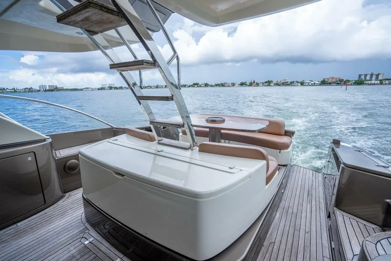Slide: The Image of Luxurious 2012 Riva Sport 56 yacht deck with seating, overlooking serene waters. - 10