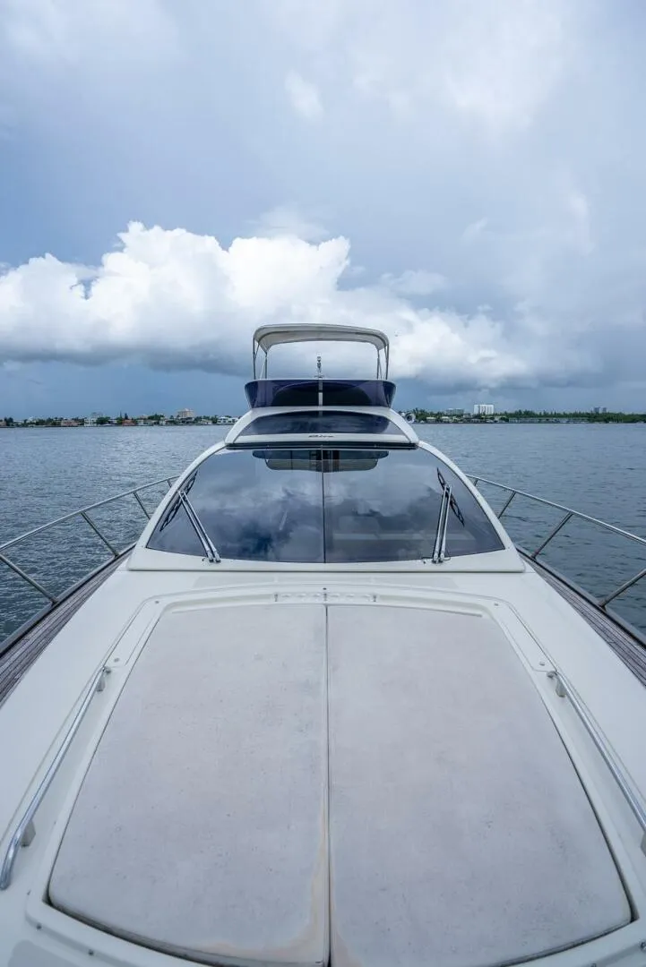 Slide: The Image of 2012 Riva Sport 56 yacht on calm water under cloudy sky. - 12