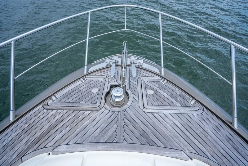 Slide: The Image of Bow of 2012 Riva Sport 56 yacht with wooden deck and metal railings. - 18