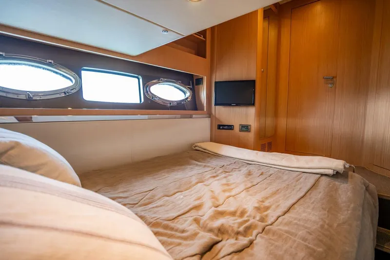 Slide: The Image of Luxurious cabin interior of 2012 Riva Sport 56 yacht with cozy bed and porthole windows. - 34