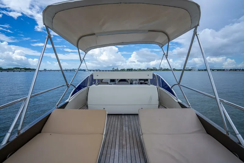 Slide: The Image of Luxury Riva Sport 56 yacht deck with sun loungers, 2012 model, on calm waters. - 20