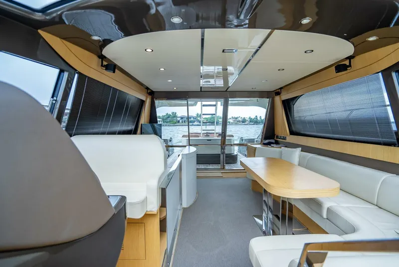Slide: The Image of Luxurious interior of a 2012 Riva Sport 56 yacht with modern seating and panoramic windows. - 25