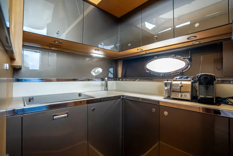 Slide: The Image of Modern kitchen interior on a 2012 Riva Sport 56 yacht, featuring sleek cabinetry and appliances. - 31