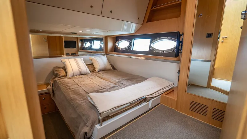 Slide: The Image of Luxurious cabin interior of 2012 Riva Sport 56 yacht with cozy bed and porthole windows. - 35