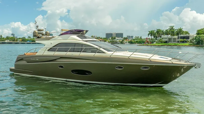 Slide: The Image of 2012 Riva Sport 56 yacht on calm water, with a scenic city backdrop. - 4