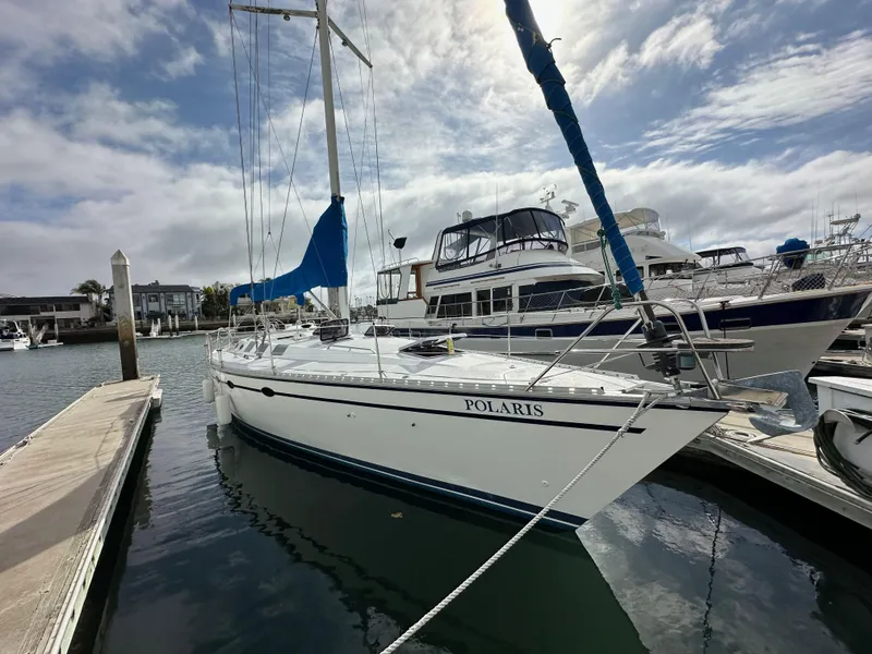Slide: The Image of 1987 Hunter Legend 45 sailboat docked in marina under cloudy sky. - 1