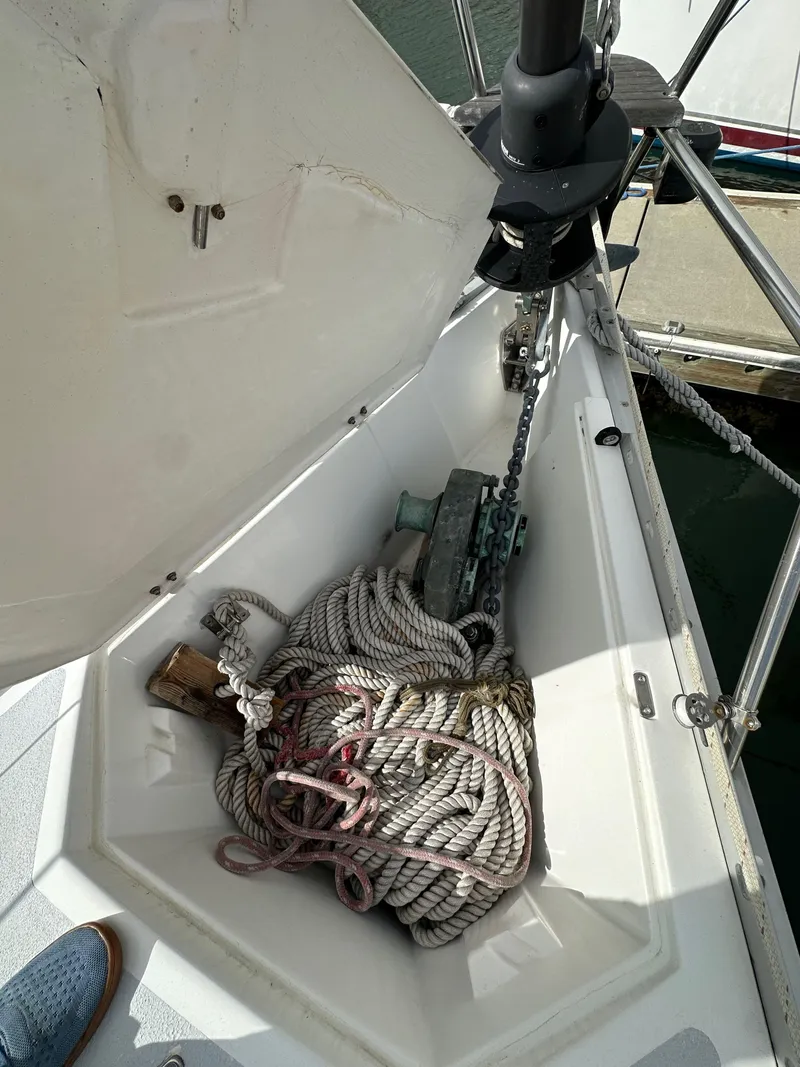 Slide: The Image of Anchor locker of 1987 Hunter Legend 45 sailboat with ropes and chain. - 13