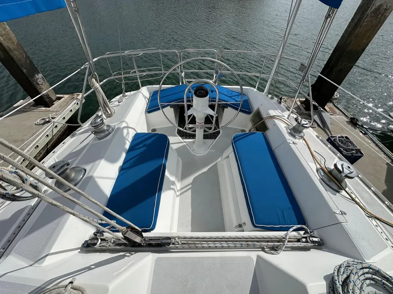 Slide: The Image of Cockpit of 1987 Hunter Legend 45 sailboat with blue cushions and steering wheel. - 17