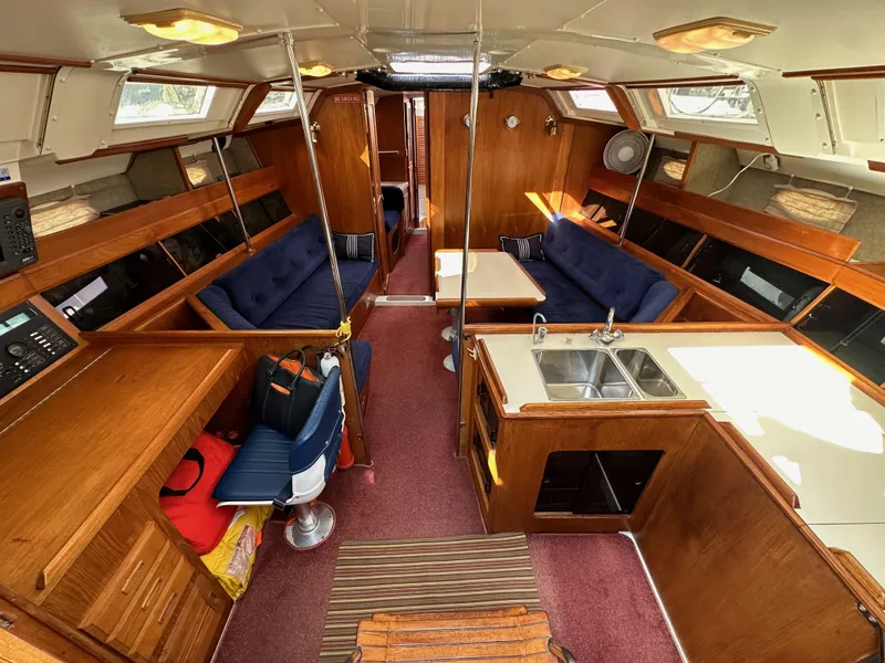 Slide: The Image of Interior of 1987 Hunter Legend 45 sailboat with wood finish and blue seating. - 26