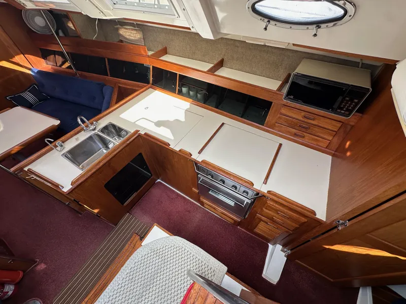 Slide: The Image of Interior of 1987 Hunter Legend 45 yacht with kitchen and seating area. - 27