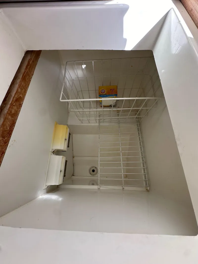 Slide: The Image of Interior view of a 1987 Hunter Legend 45 storage compartment with wire basket. - 32