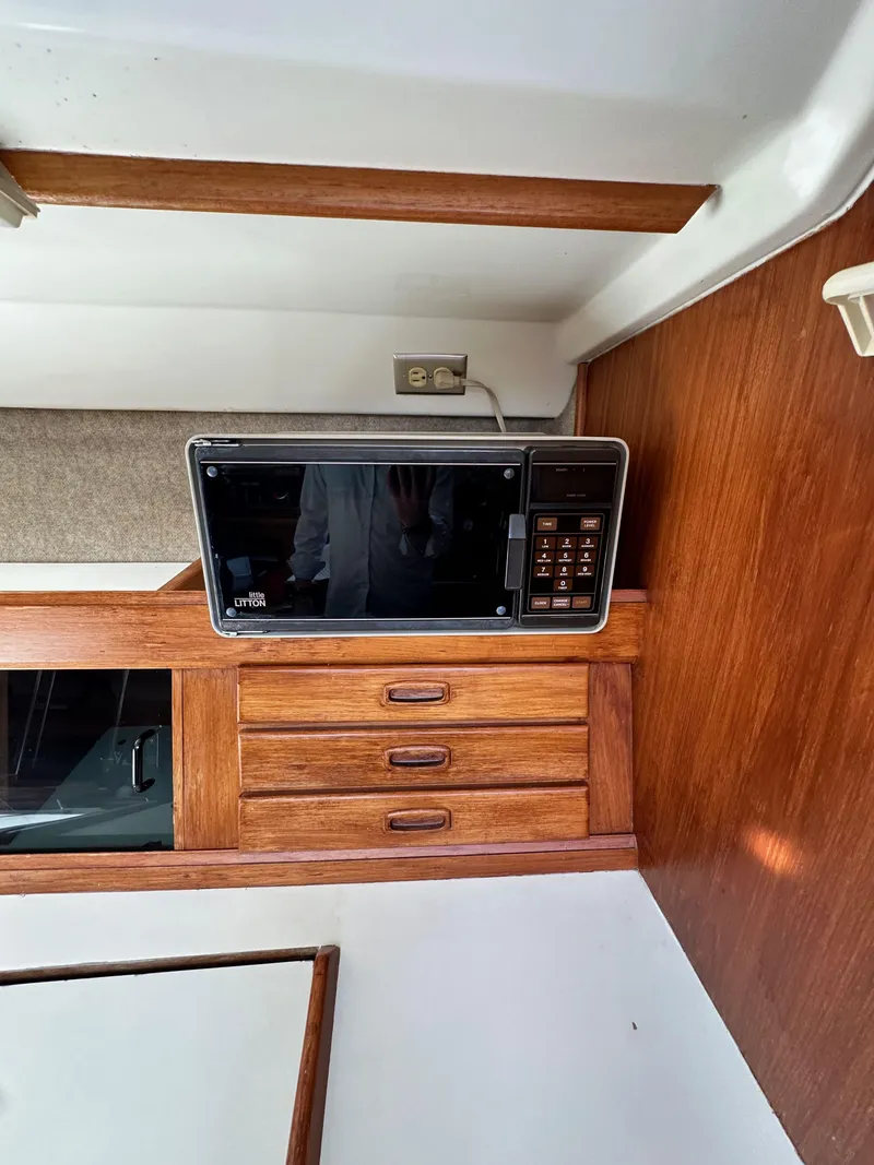 Slide: The Image of Microwave on wooden cabinet inside 1987 Hunter Legend 45 boat interior. - 34