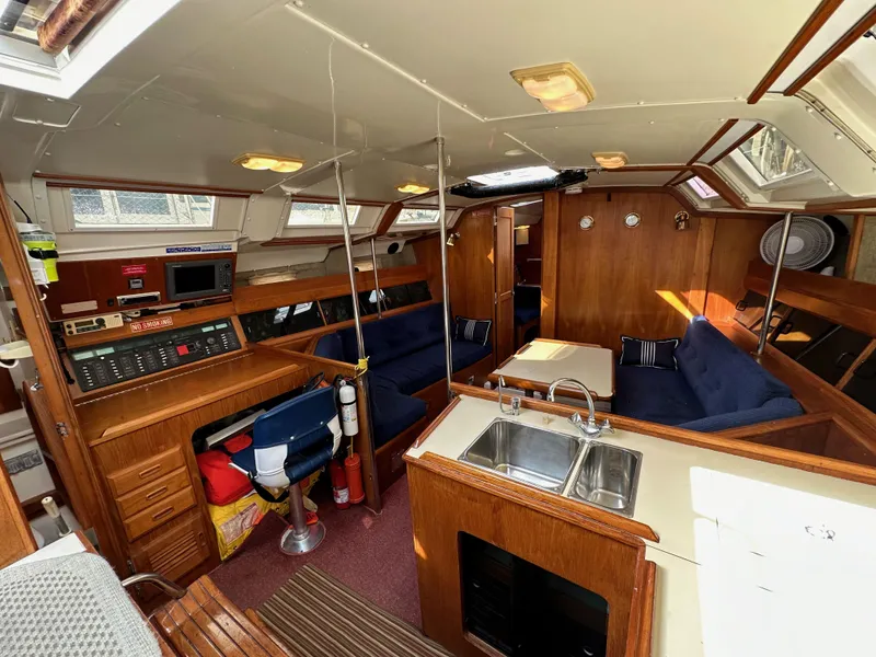 Slide: The Image of Interior of 1987 Hunter Legend 45 sailboat with wood finish and blue seating. - 36