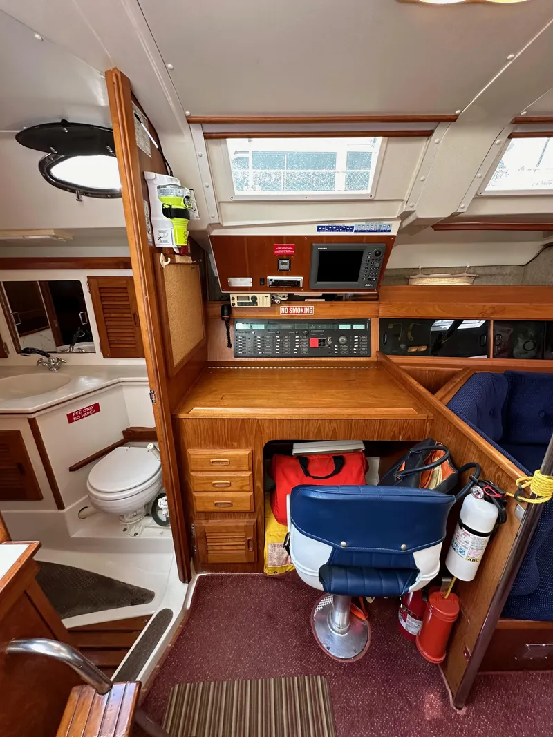 Slide: The Image of Interior of 1987 Hunter Legend 45 sailboat with navigation station and compact bathroom. - 37